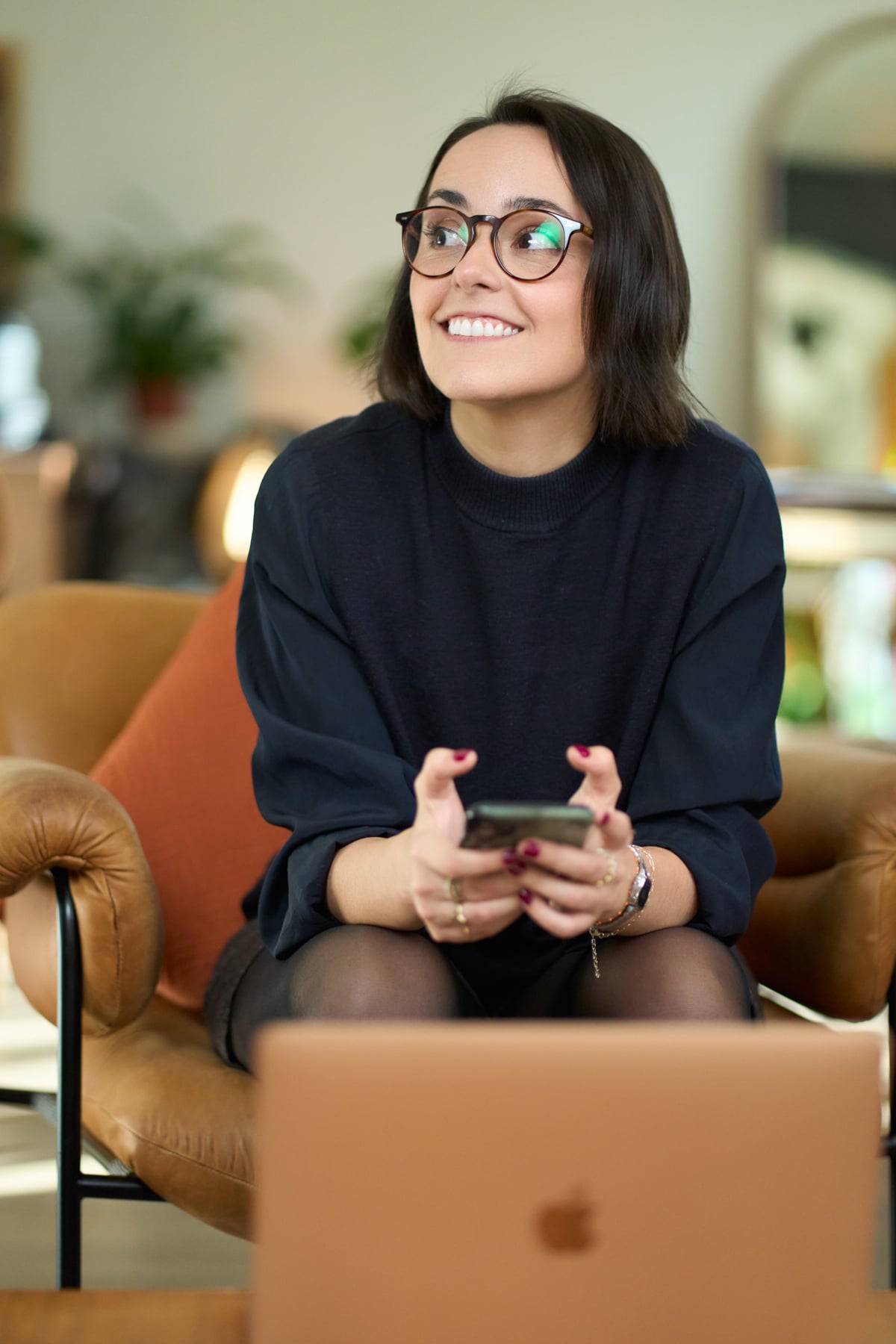 Personal branding portrait of Hélène Brandily, London copywriter, working at her laptop with a coffee at The Designer's Penthouse