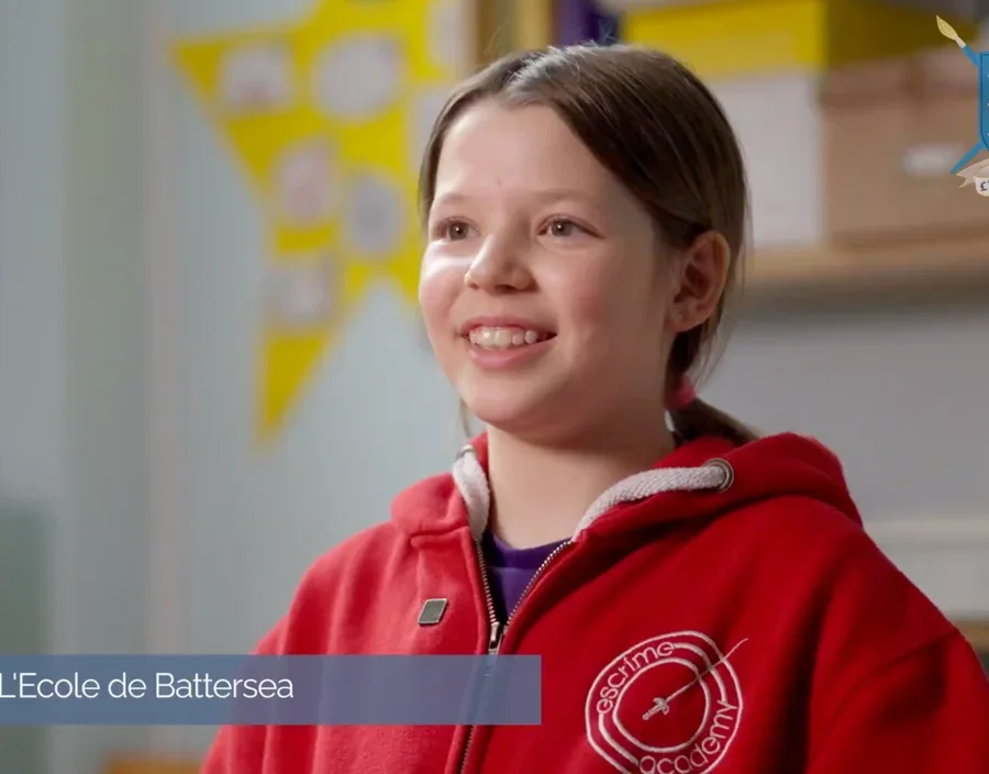 Young students practising fencing in the École de Battersea gymnasium, captured mid-lunge during a character education session in Battersea, London.
