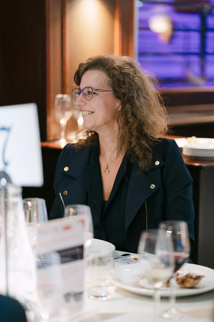 Business leaders networking on a private boat cruising the Seine during the Diligent corporate event in Paris, captured for event film and editorial stills