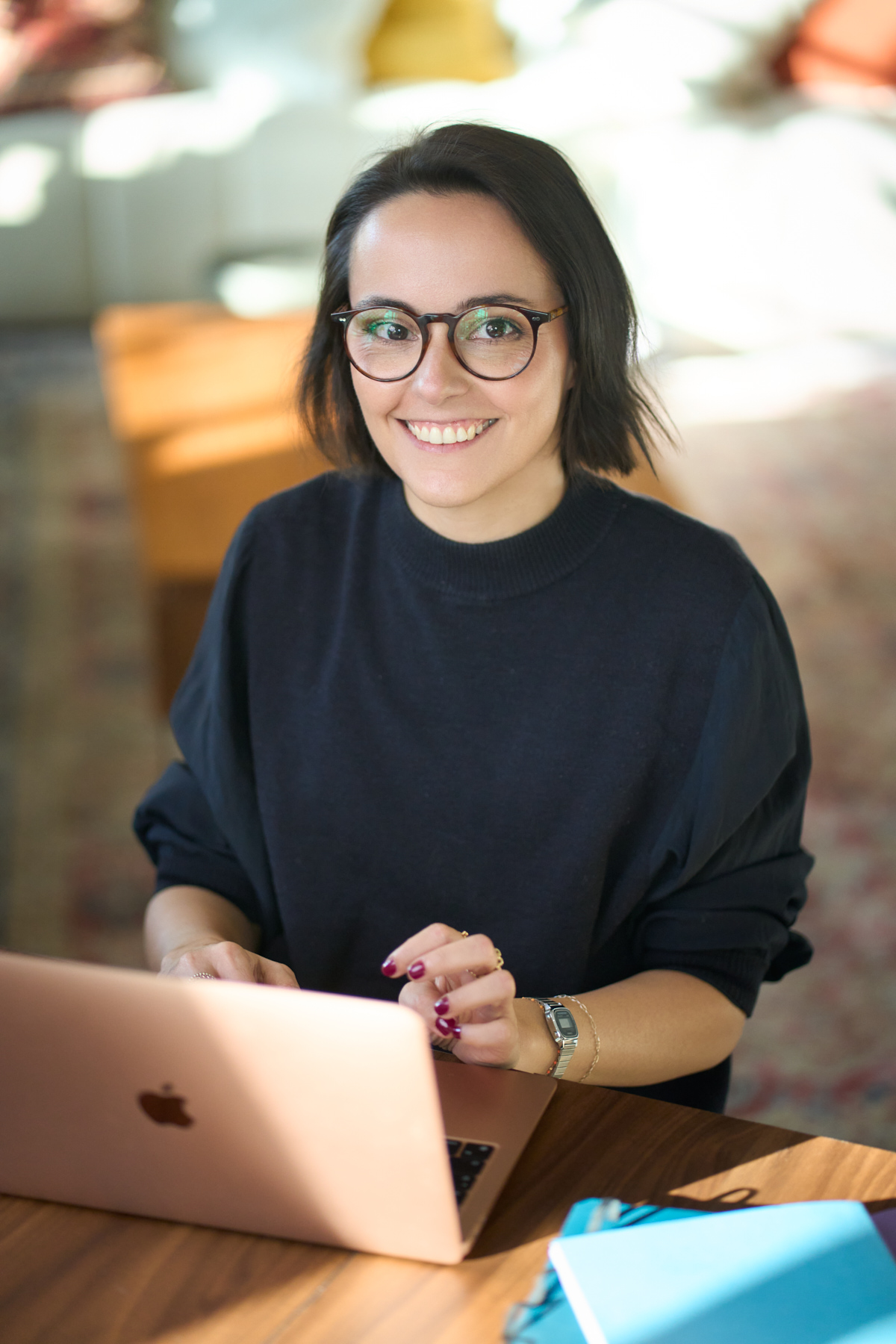 Personal branding portrait of Hélène Brandily, London copywriter, working at her laptop with a coffee at The Designer's Penthouse